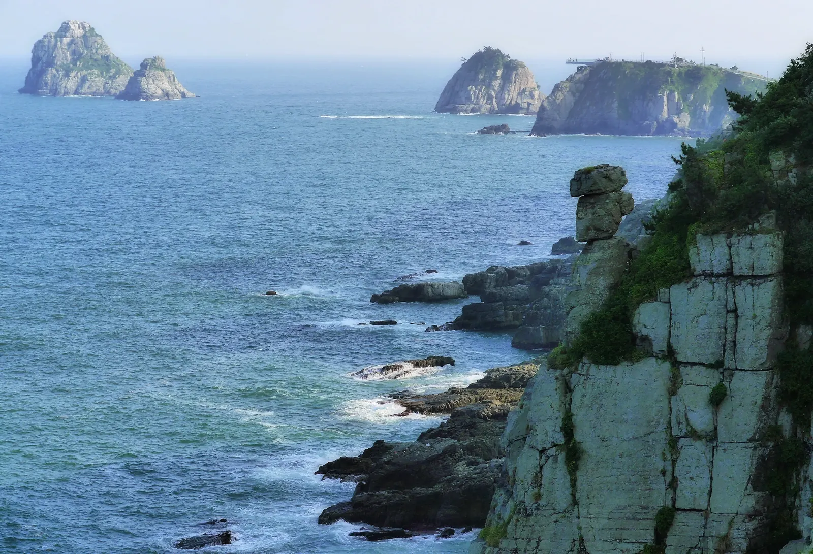 Rocky coastal cliffs at Igidae with Oryukdo islets in the distance, Busan